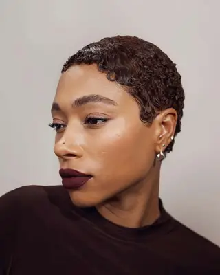 A cropped pixie hairstyle with smoothed fingerwaves