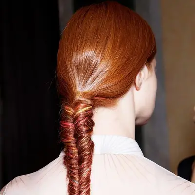 woman with red hair in a fishtail braid