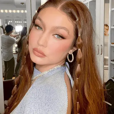 gigi hadid wearing middle part hairstyle with bubble braids