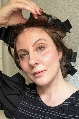 Three people testing hot rollers, one after their use and two with rollers still in their hair