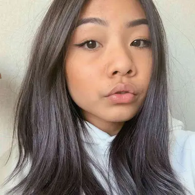 Woman with cool-toned brown hair with subtle silver balayage