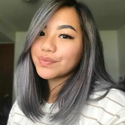 Woman with medium-length silver balayage hair