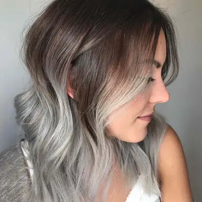 Side view of smoky silver balayage hair with brunette roots