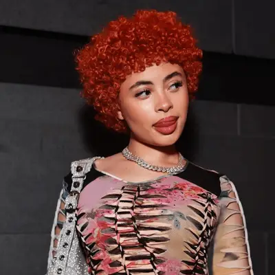 Ice Spice with a curly burgundy afro