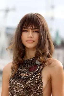 Zendaya in voluminous curls with bangs