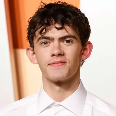 Joe Locke with curly hair on the red carpet