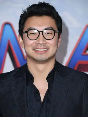 Simu Liu with a slightly messy hairstyle on the red carpet