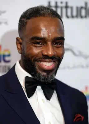 Charles Venn with salt-and-pepper hair and beard on the red carpet
