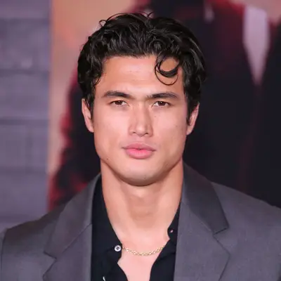 Charles Melton with tousled hair on the red carpet
