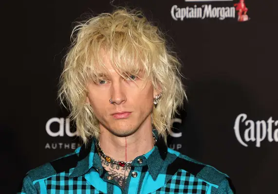 Machine Gun Kelly with a shag haircut on the red carpet