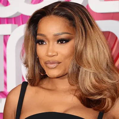 Keke Palmer wearing bouncy blowout with honey blonde highlights