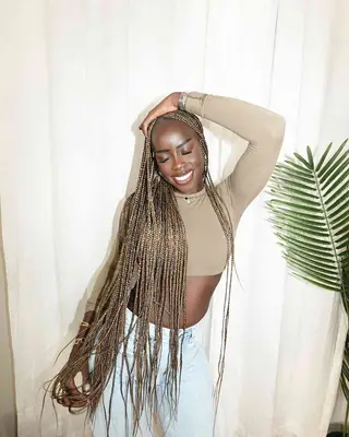 Golloria with protective braids in a dirty blonde color