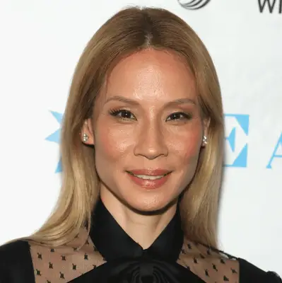 Chrissy Teigen in a sequin dress and full glam with her dirty blonde air in effortless waves