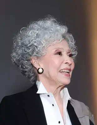 Rita Moreno with gray ringlets 