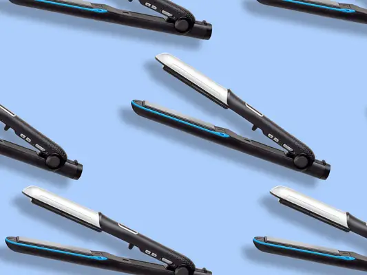Several hair straighteners on a blue background