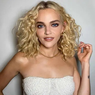 Actor Madeline Brewer with shoulder-length blonde curls