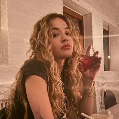 Actor Madeline Brewer with a curly blonde bob