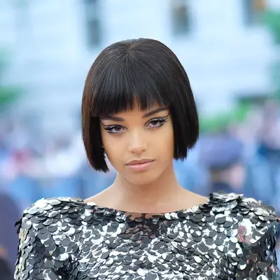 Ella Balinska wears a layered wedge haircut with bangs