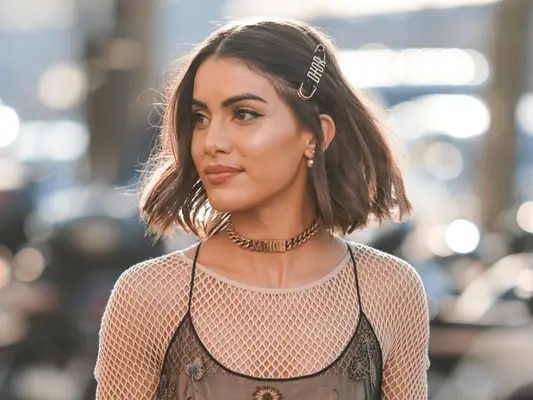 Camila Coelho with a modern wedge bob haircut wearing a dior hair clip 