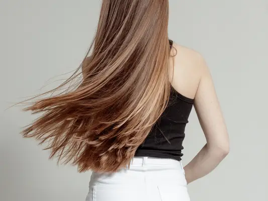 A woman from the back, showing long, straight hair
