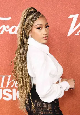 Actor Lexi Underwood with long blonde braids with curls