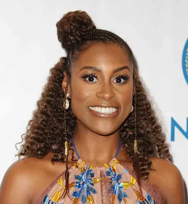 Isssa Rae with hair braided in the front, curled in the back, and a bun toward the middle