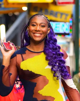 Athlete Aliyah Boston with purple braids and curls