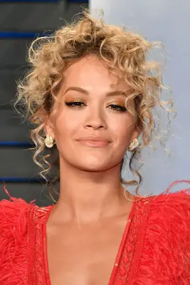Rita Ora loose, curly updo