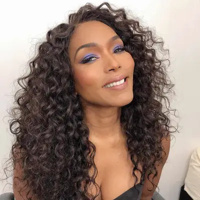 Angela Bassett with long, curly brown hair