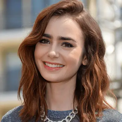 Sophie Turner attends the Louis Vuitton show with soft natural waves in her extra long copper dyed hair