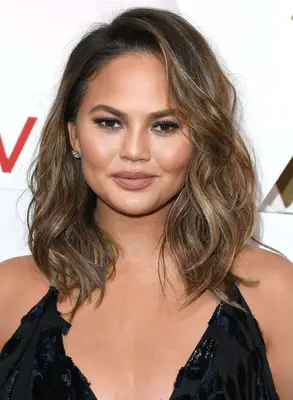 Chrissy Teigen rocks beach waves