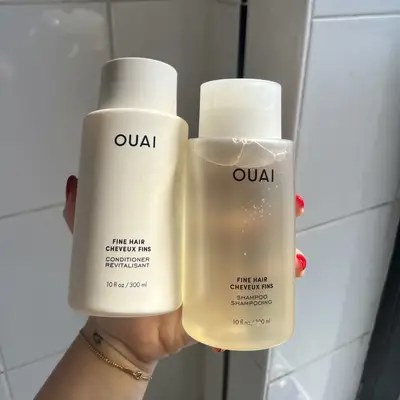 Ouai Shampoo and Conditioner for Fine Hair bottles in hand