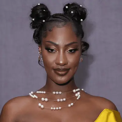 Singer Tems wearing two space buns