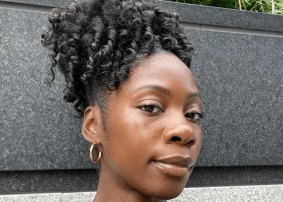 woman with coily hair in top knot