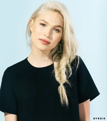 woman with blonde hair styled in a messy fishtail braid