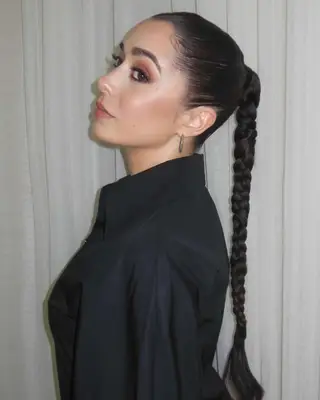 Cristin Milioti in a side profile view with braided hair styled in a long ponytail