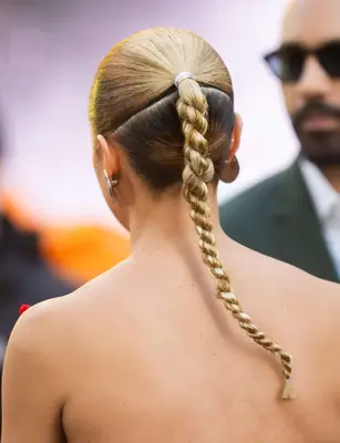 The back view of a braided hairstyle, Alex Lanipekun in the blurred background