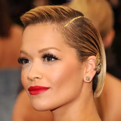 Rita Ora at The Met Gala with gold flitter in her side parting