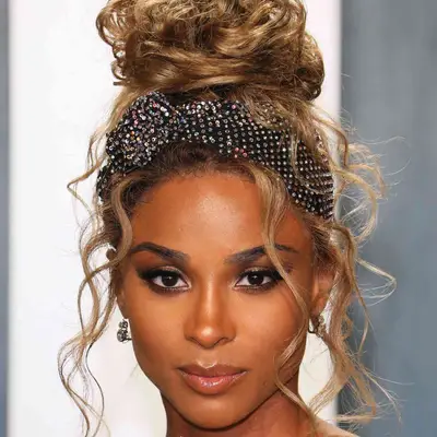 Ciara wears a top knot with a bedazzled headband