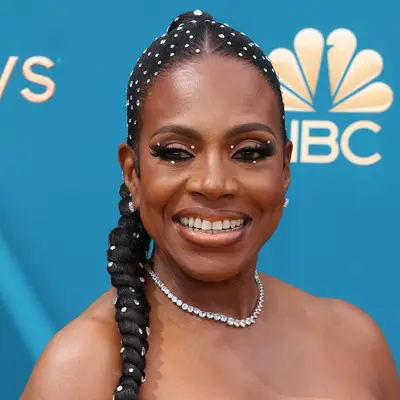 Sheryl Lee Ralph wears jewels scattered throughout her high braided hairstyle