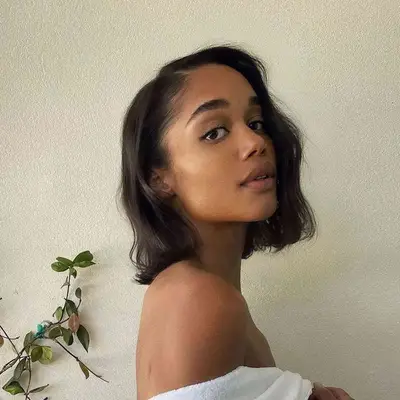 Laura Harrier with a wavy side part bob