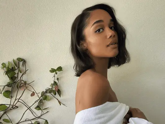 Laura Harrier with a wavy side part bob