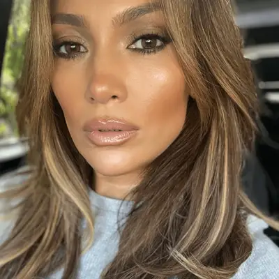 Jennifer Lopez with brown hair and golden highlights