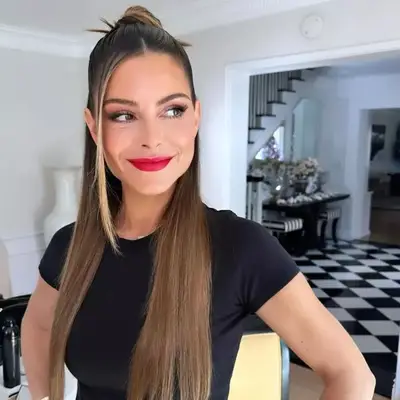 A sleek half up, half down hairstyle on TV personality Maria Menounos 