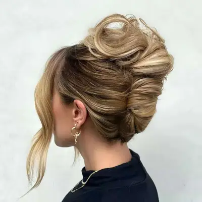 A voluminous French twist hairstyle, viewed in profile