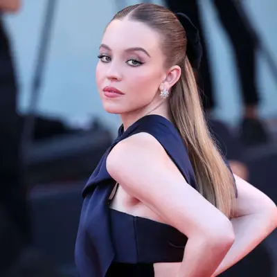 Sydney Sweeney wears her hair half-up with a velvet bow