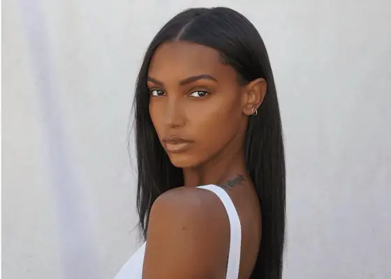 Jasmine Tookes with straight hair looking over her shoulder