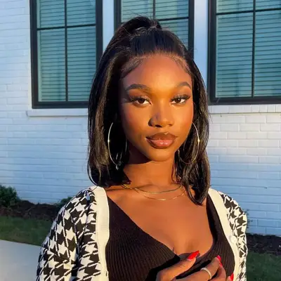 Model of a girl with a medium length bob and a 2000s-inspired pouf secured in a high ponytail.