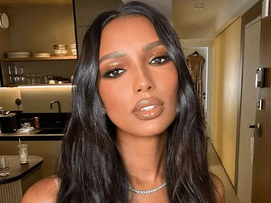 jasmine tookes wearing long wavy hair and neutral makeup