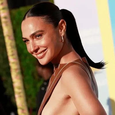 Gal Gadot on the red carpet with a wet-looking, slicked back ponytail.